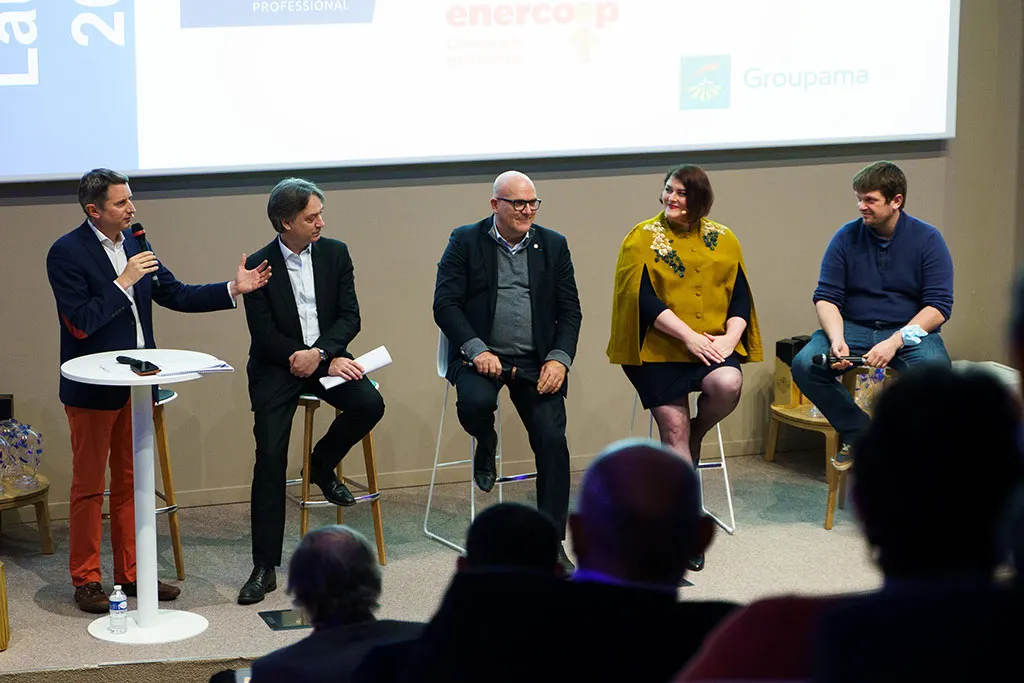 A round table at the NextGen Enterprise Summit 2021: five speakers on stage facing the audience